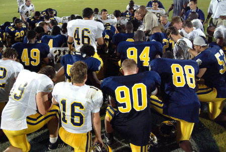 Football Players in Huddle